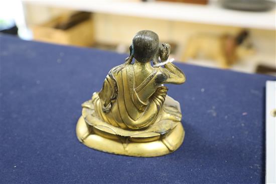 A Sino-Tibetan gilt bronze seated figure of Milarepa, H. 14cm